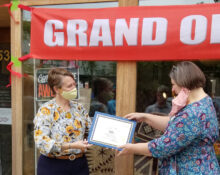 Quilts by Commission Owner Stephanie McCall, at right, receives a certificate from CEDA Business Development Specialist Meg Goloub while Senator Pam Helming looks on during a grand opening ceremony September 18, 2021, at the business's new location at 53 Genesee Street in downtown Auburn. Stephanie received assistance from CEDA in acquiring a loan from the City of Auburn's Small Business Assistance Program.